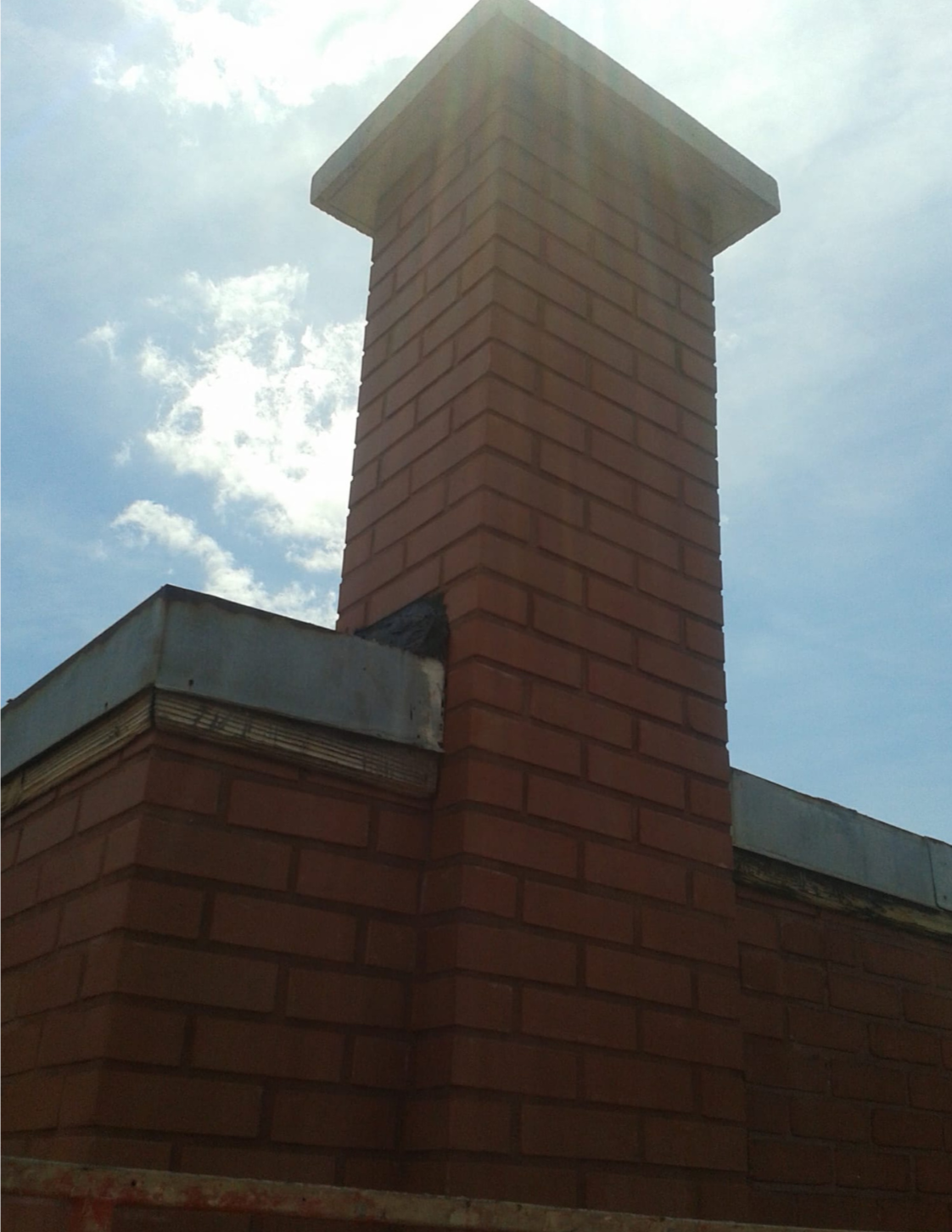 Completed brick chimney with concrete cap