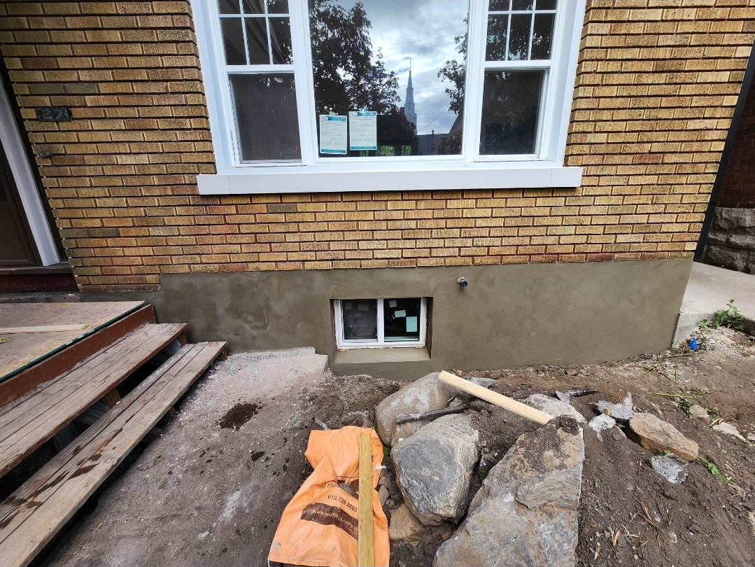 Smooth finished parging on the same residential foundation