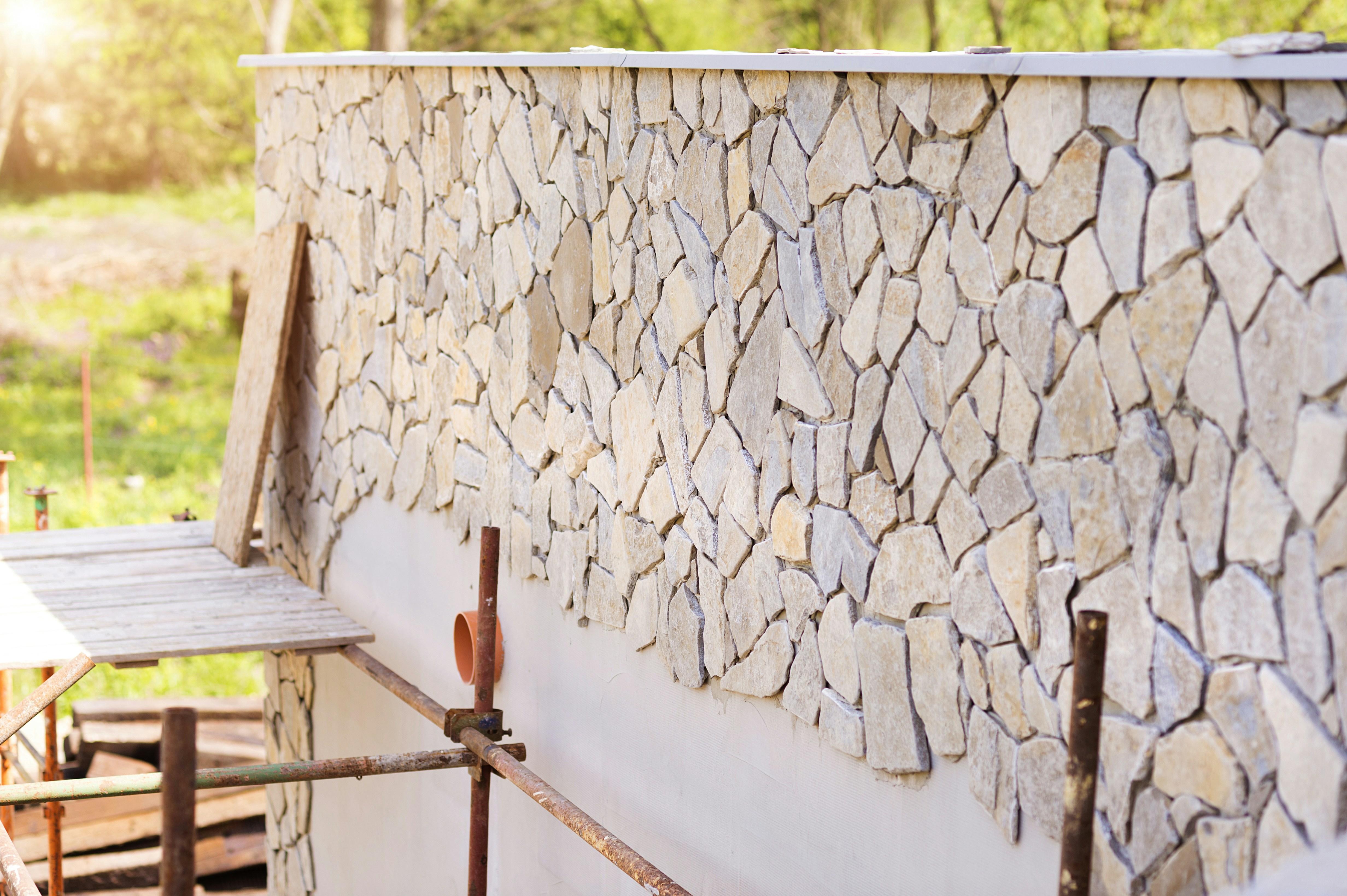 Natural stone veneer installation showing fitted stone and mortar joints