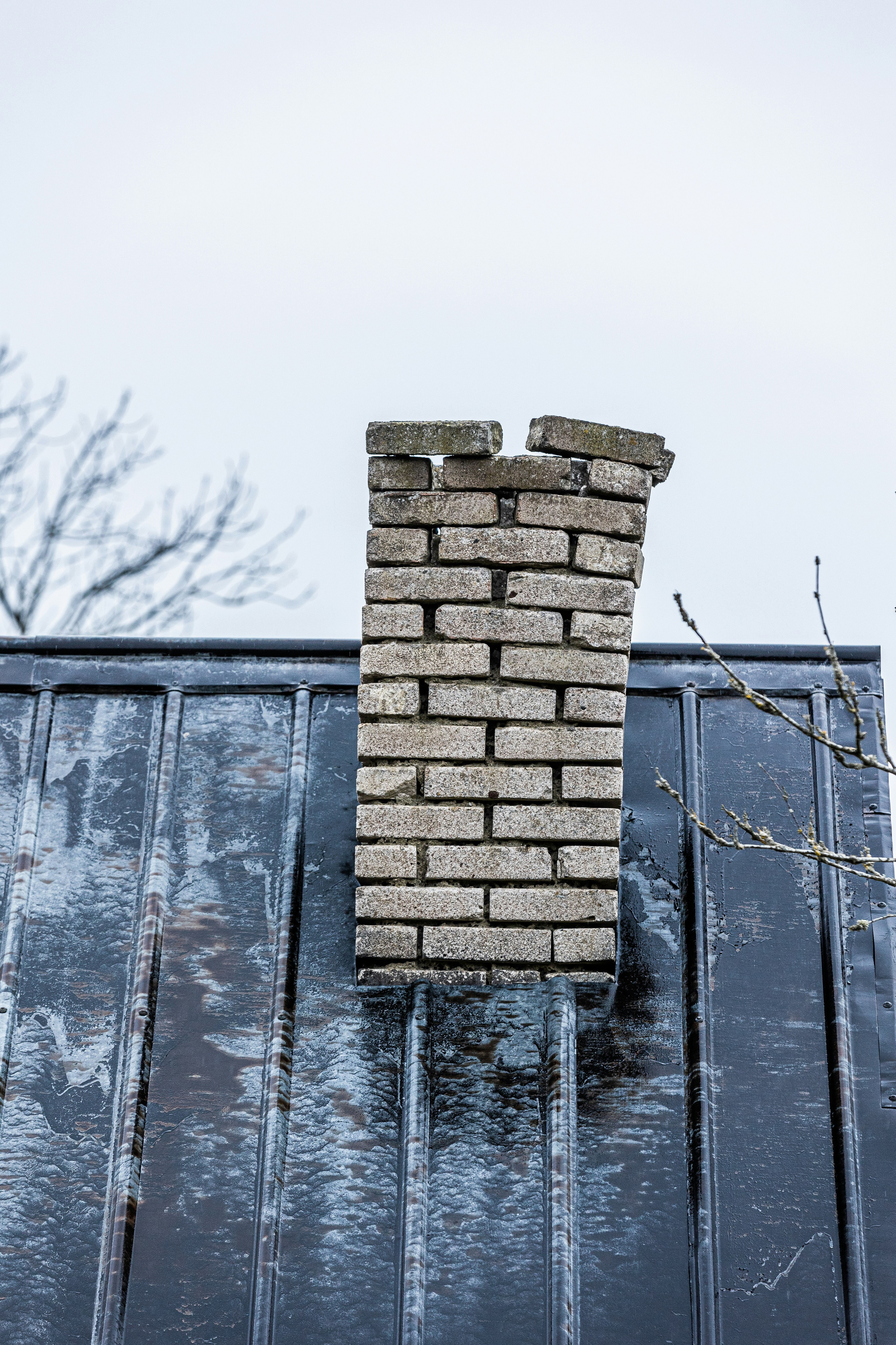 Weathered brick chimney showing exposed mortar joints